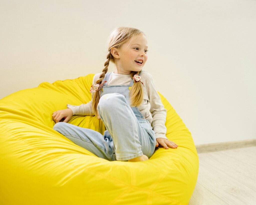 child sititng in bean bag chair for a portable sensory room