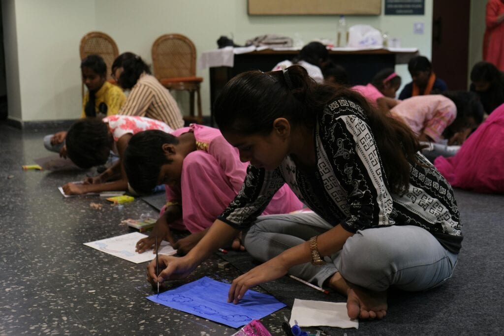 art as a classroom sensory activity for middle school students drawing on paper on the floor